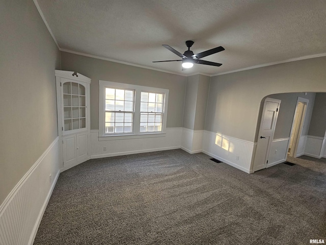 unfurnished room featuring dark colored carpet, a textured ceiling, and ceiling fan