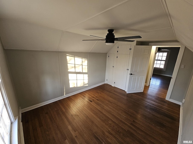 additional living space with ceiling fan, dark hardwood / wood-style flooring, and vaulted ceiling