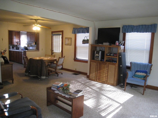 living room with light carpet and ceiling fan