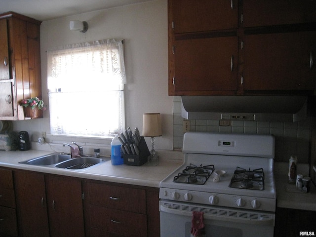 kitchen featuring sink and white gas range oven