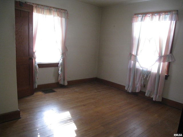 unfurnished room with wood-type flooring