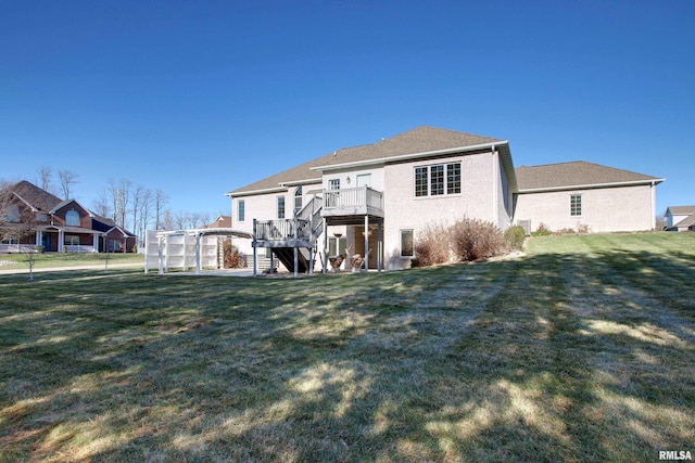 back of house featuring a lawn, a deck, and a pergola