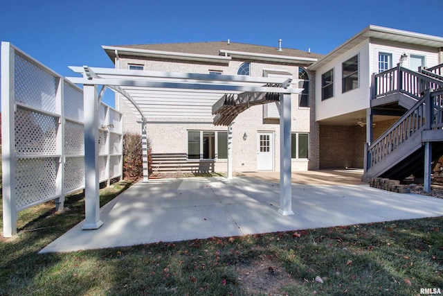 rear view of house featuring a pergola and a patio