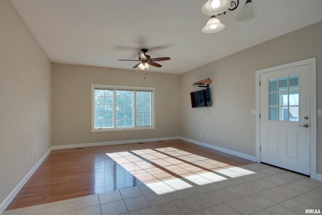 interior space featuring ceiling fan and light tile patterned floors