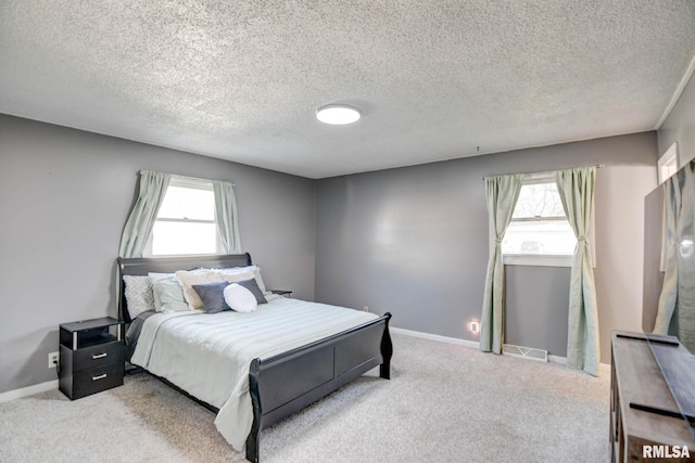 carpeted bedroom featuring a textured ceiling