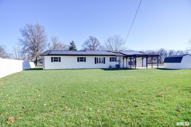 back of house featuring a lawn, a pergola, and central AC