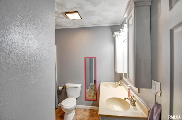 bathroom featuring ornamental molding, vanity, and toilet