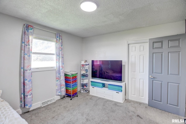 game room with light carpet and a textured ceiling