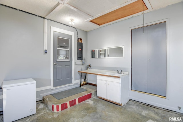 bathroom with concrete flooring, electric panel, and vanity