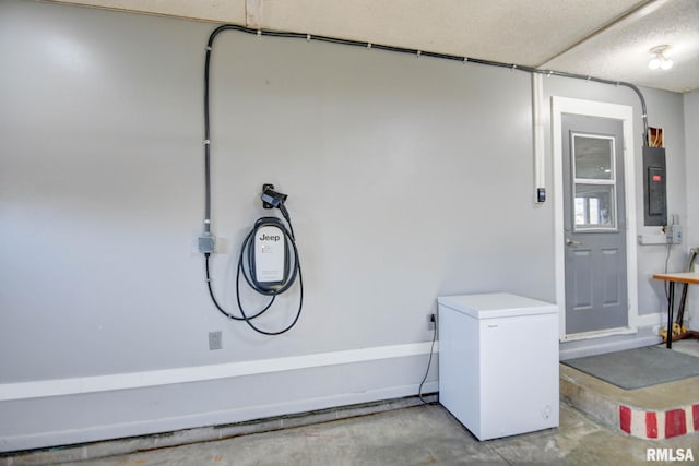 interior space with electric panel and refrigerator