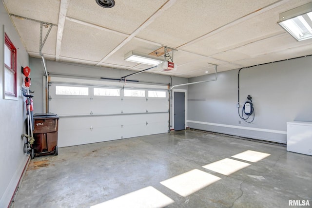 garage featuring a garage door opener and fridge