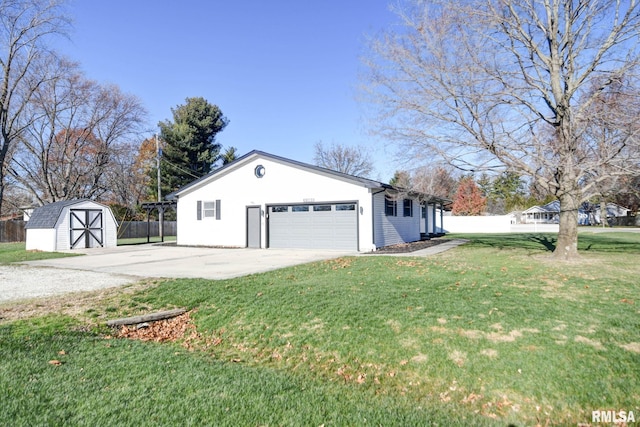 view of side of property featuring a lawn, a garage, and a storage shed