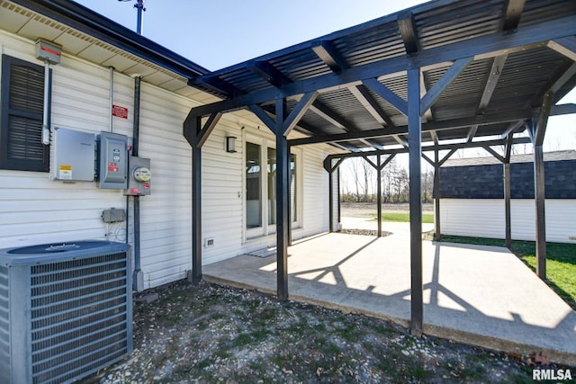 view of patio featuring cooling unit and a shed