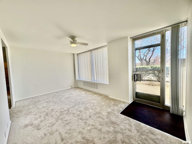 carpeted foyer with ceiling fan