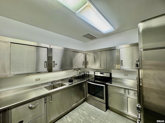 kitchen featuring stainless steel counters, sink, and stainless steel appliances