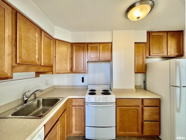 kitchen featuring white appliances and sink