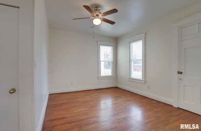 empty room with light hardwood / wood-style flooring and ceiling fan