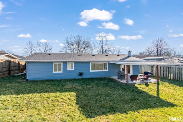 rear view of house with a lawn and a patio area