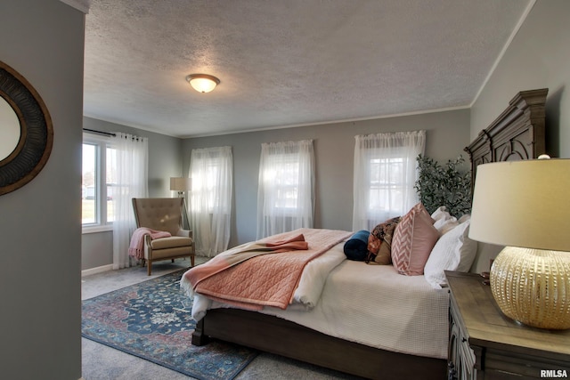 bedroom featuring carpet flooring, a textured ceiling, and crown molding