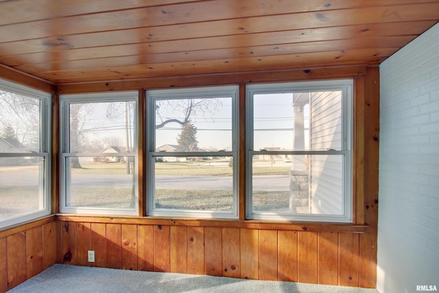 unfurnished sunroom with wooden ceiling