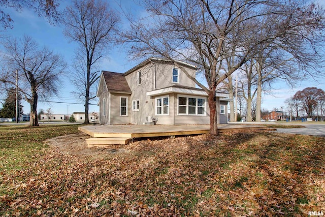 back of property featuring a wooden deck