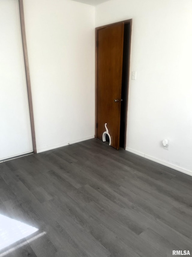 spare room featuring dark hardwood / wood-style flooring