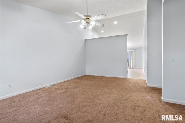 carpeted empty room featuring ceiling fan and vaulted ceiling