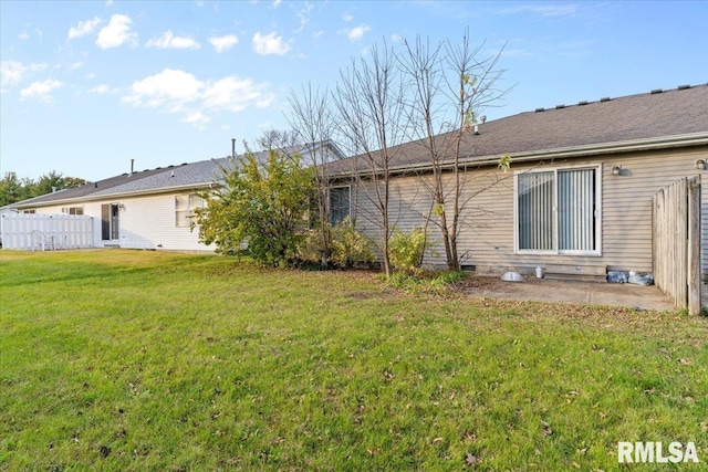 back of house featuring a yard and a patio area