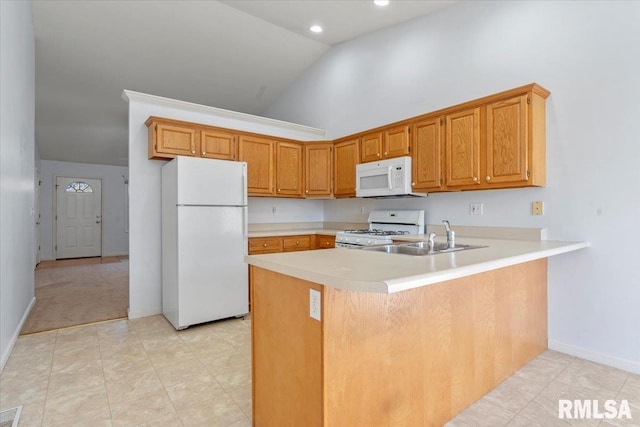 kitchen featuring kitchen peninsula, sink, high vaulted ceiling, and white appliances