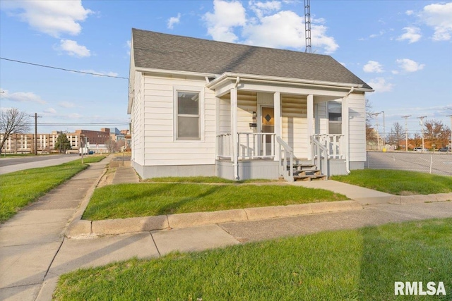 bungalow-style home featuring a front yard