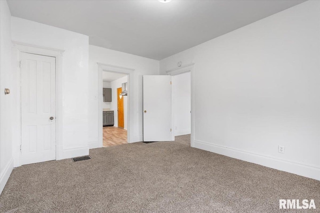 unfurnished bedroom featuring light carpet