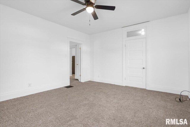 carpeted spare room with ceiling fan