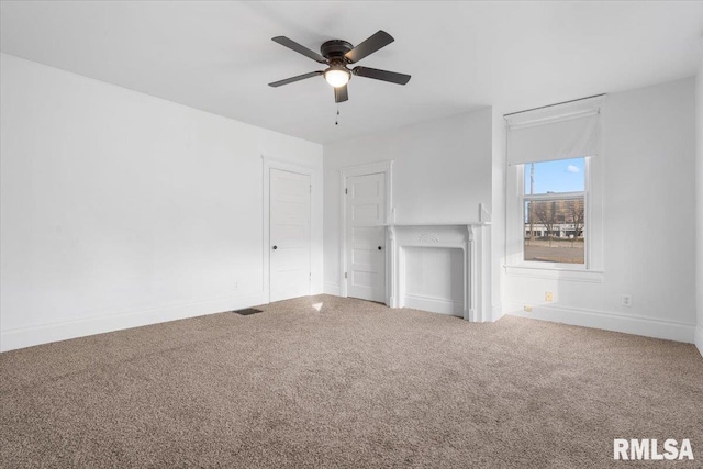 unfurnished living room with ceiling fan and carpet floors