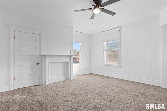 unfurnished living room featuring ceiling fan and carpet floors