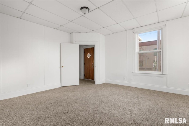 unfurnished room featuring carpet floors and a paneled ceiling