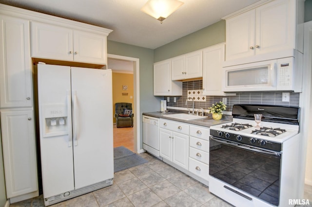 kitchen with white appliances, backsplash, white cabinets, light tile patterned flooring, and sink