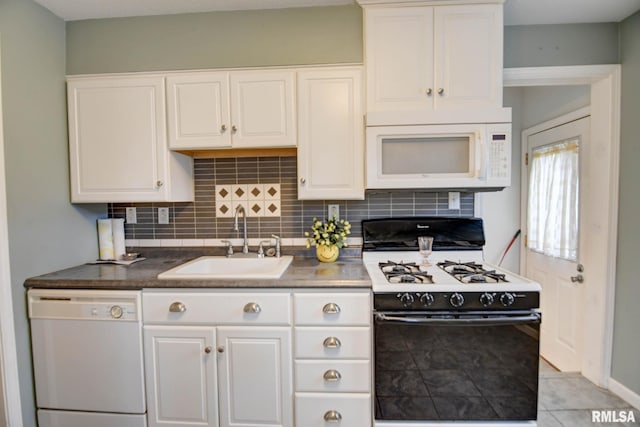 kitchen with sink, white appliances, tasteful backsplash, and white cabinets