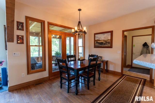 dining area featuring a chandelier and hardwood / wood-style flooring