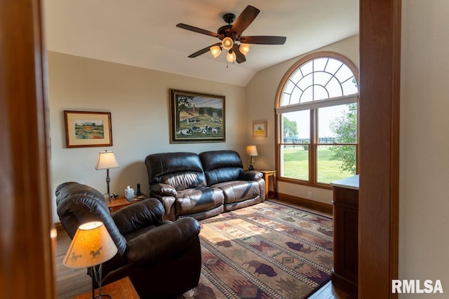 living room with ceiling fan, vaulted ceiling, and hardwood / wood-style flooring