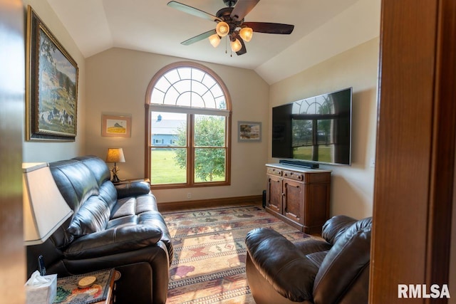 living room with ceiling fan and vaulted ceiling