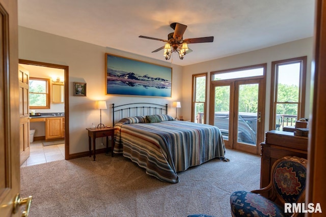 bedroom featuring ceiling fan, access to exterior, french doors, and multiple windows