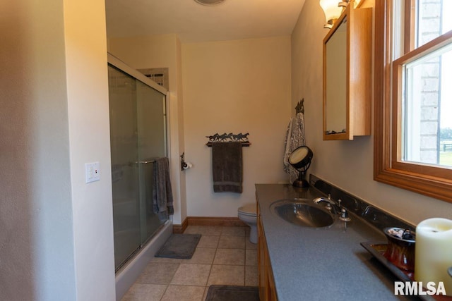 bathroom featuring tile patterned floors, plenty of natural light, and a shower with shower door