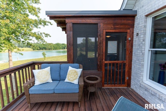 wooden terrace featuring a water view