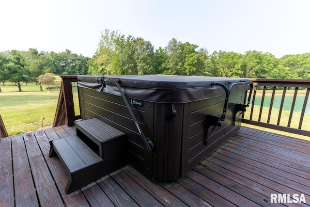 deck featuring a lawn and a hot tub