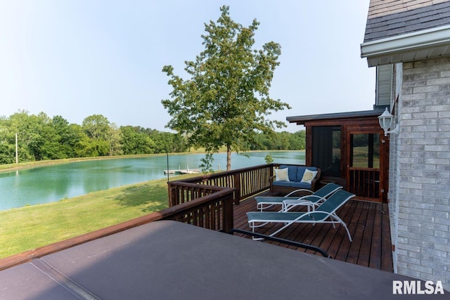 wooden deck with a sunroom, a yard, and a water view