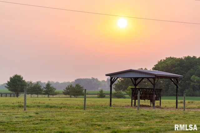 view of community featuring a gazebo, a lawn, and a rural view