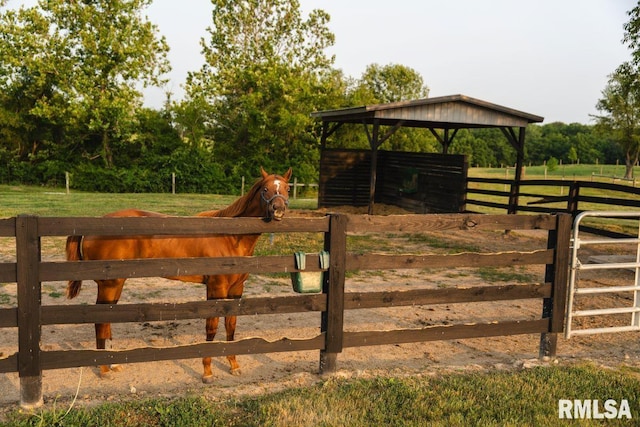 view of gate with a rural view