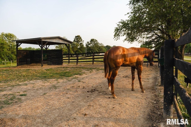 view of stable with a rural view