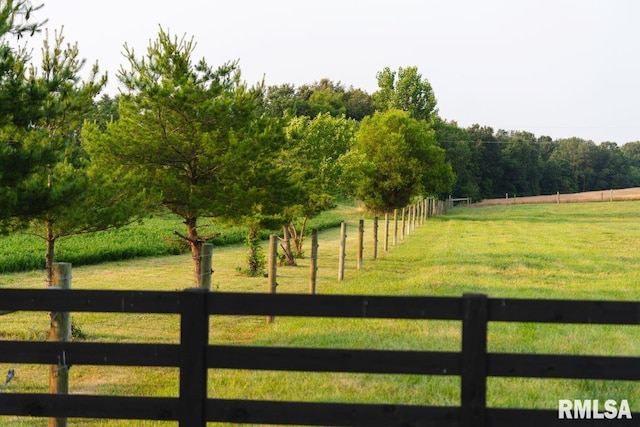 view of gate with a yard and a rural view