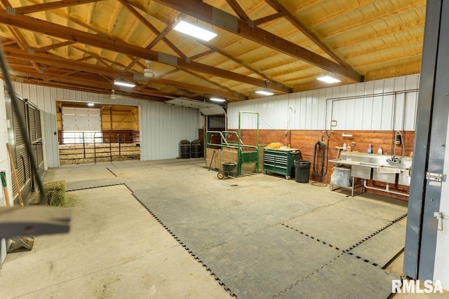 interior space with vaulted ceiling with beams and concrete floors